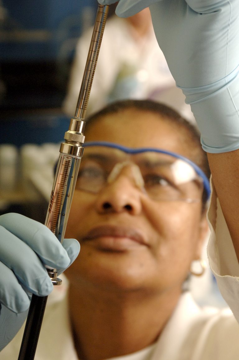 Scientist holding beaker