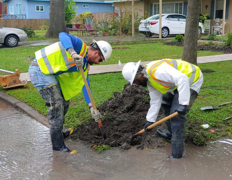 field workers working in puddle