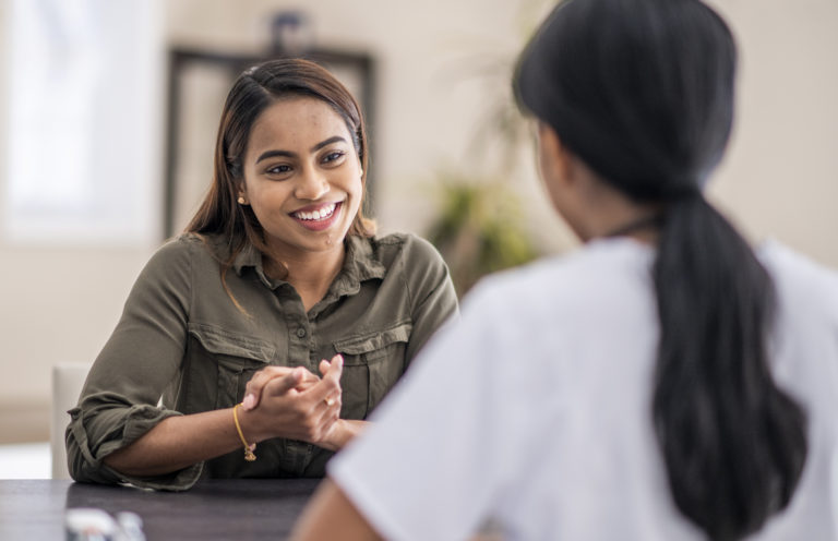 woman speaking to a counselor