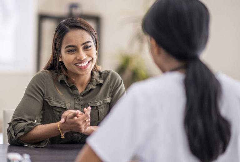 woman speaking to a counselor